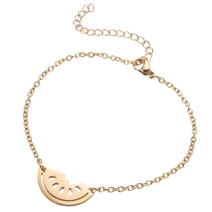 Macro detail of gold stainless steel bracelet featuring a sliced watermelon charm