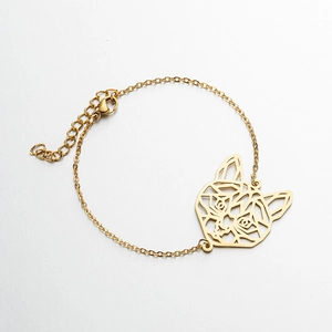 Detail of gold hollow cat head pendant on dainty stainless steel chain bracelet