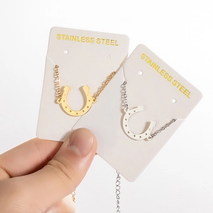 Golden and silver horseshoe pendant necklaces in polished stainless steel for women