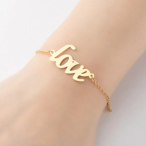 French vintage style gold love pendant bracelet for women on wrist with elegant link chain