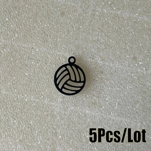 Detailed view of five black volleyball-shaped hollow stainless steel pendants for DIY jewelry