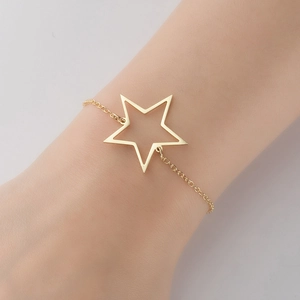 Close-up of gold stainless steel bracelet featuring a delicate hollow star-shaped pendant