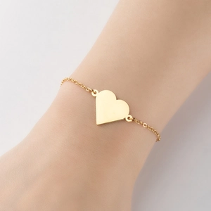 Minimalist 18K gold plated stainless steel heart pendant bracelet worn on a female wrist