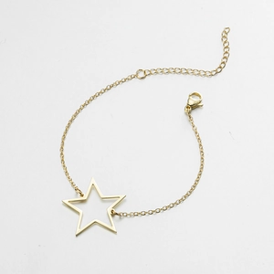 Close-up of golden stainless steel star bracelet with adjustable link chain and lobster clasp