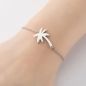 Minimalist silver stainless steel bracelet featuring a tropical palm tree charm for women
