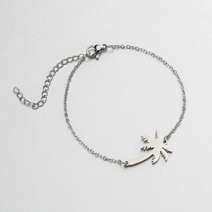 Detail view of silver palm tree pendant with adjustable lobster clasp on steel bracelet