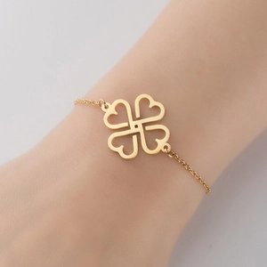 Poliertes goldenes Herz-Kleeblatt-Armband am Handgelenk für einen eleganten Look
