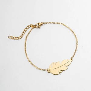 Close-up of golden leaf pendant and adjustable lobster clasp on minimalist chain