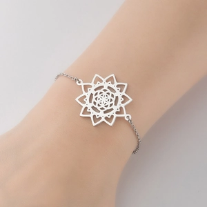 Detailed close-up of a silver mandala pendant bracelet on a wrist in a minimalist style