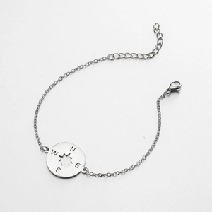 Stainless steel compass pendant bracelet with engraved N E S W letters and star cutout