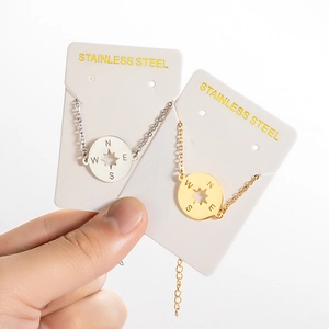 Polished stainless steel compass pendant bracelets in gold and silver finishes