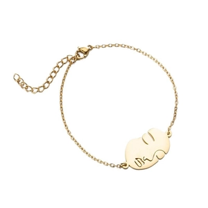 Bracelet doré à maillons fins avec pendentif visage abstrait et fermoir mousqueton réglable