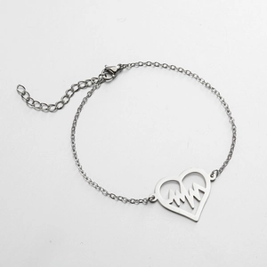 Detail of silver heartbeat charm bracelet with adjustable chain and lobster clasp