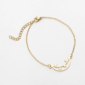 Detail of gold crescent moon and star pendant on a delicate chain with lobster clasp