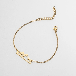 Detail of gold mountain silhouette pendant bracelet with adjustable chain and lobster clasp