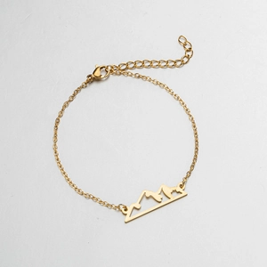 Detail of mountain peak pendant bracelet with adjustable lobster clasp and gold finish