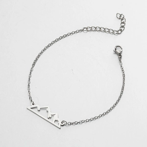 Detail of stainless steel mountain peak pendant bracelet with adjustable lobster clasp
