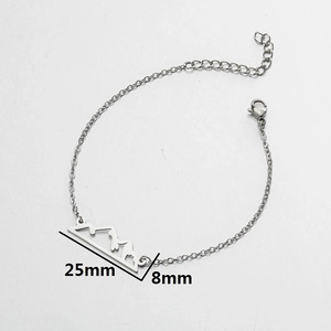 Polished stainless steel bracelet featuring mountain peak silhouette charm on cable chain