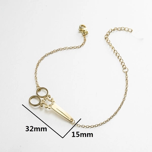 Vintage gold scissor pendant necklace with filigree detail on adjustable metal chain