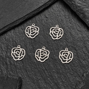 5pcs silver stainless steel rose flower pendants with heart centers on black slate