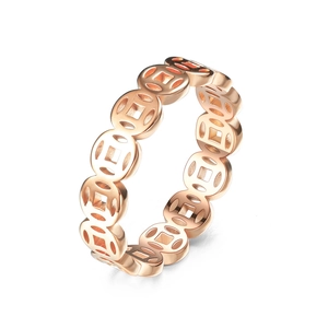Macro shot of rose gold copper coin ring with hollowed-out vintage circular details
