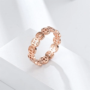 Rose gold stainless steel ring with hollowed ancient coin design on a white podium