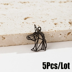 Close-up of matte black geometric hollow unicorn pendant on a natural stone base