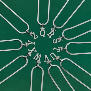 Detailed arrangement of silver crown alphabet pendants Q to Z on snake chains