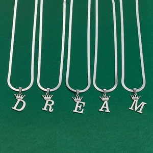Polished silver metal crown initial pendants forming DREAM word on snake chain