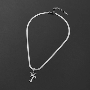 Detailed close-up of silver stainless steel snake chain with crown letter T pendant