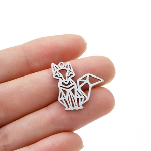 Macro shot of a geometric origami fox pendant made of polished silver stainless steel