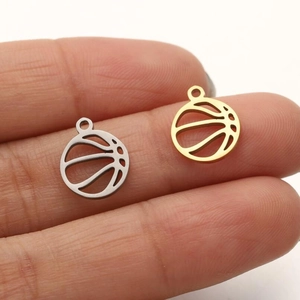 Hollow stainless steel basketball pendants in gold and silver held to show size