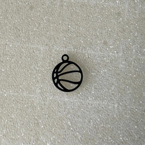 Detailed close-up of a hollow black stainless steel basketball pendant for DIY jewelry