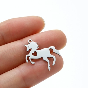 Detailed close-up of a stainless steel unicorn pendant with hollow heart design
