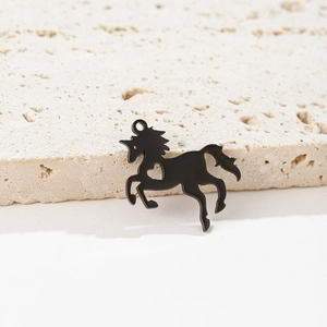 Detailed view of a black matte unicorn pendant featuring a small heart-shaped cutout