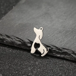 Macro shot of minimalist hollow dog pendant with heart detail on a dark stone surface