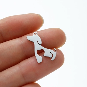 Polished stainless steel dachshund dog pendant held in hand to show the miniature size