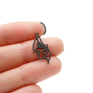 Detailed view of black minimalist cutout female face pendant for jewelry DIY projects