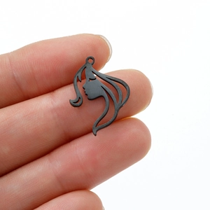 Detailed close-up showing the small black fairy face silhouette pendant in hand