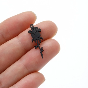Close-up of black rose pendant in 18k gold plating with detailed matte texture