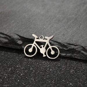 Macro shot of silver bicycle pendant detail with intricate hollowed-out metal craftsmanship