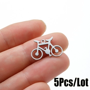 Macro detail of bicycle charm pendant in brushed stainless steel for DIY jewelry