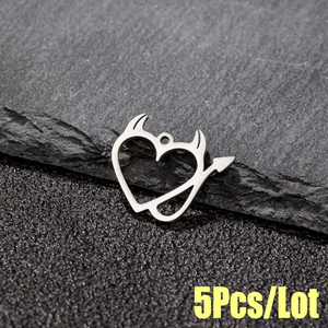 Detailed macro view of 5pcs silver devil heart pendants in polished stainless steel