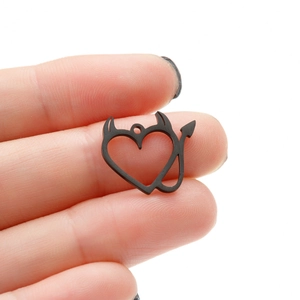 Close-up of a black heart-shaped devil pendant made of 18K gold plated stainless steel