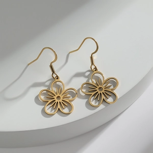 Minimalist gold hollow flower drop earrings with hook design on a white pedestal