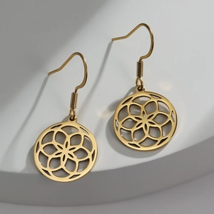 Golden stainless steel earrings with geometric mandala cutout charms on white display