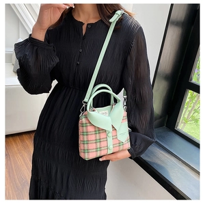 Detail of pink and green plaid crossbody bag with mint green leather collar design