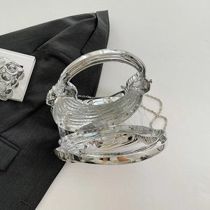 Chic silver acrylic clutch bag with a high-shine mirror finish and metal chain handle