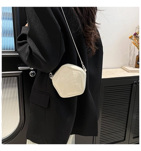 Star-shaped cream white PU leather crossbody bag with quilted star details on model