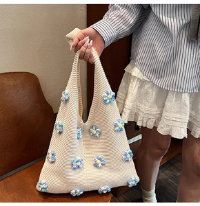 Détail de fleurs au crochet 3D colorées sur un sac à bandoulière en maille crème